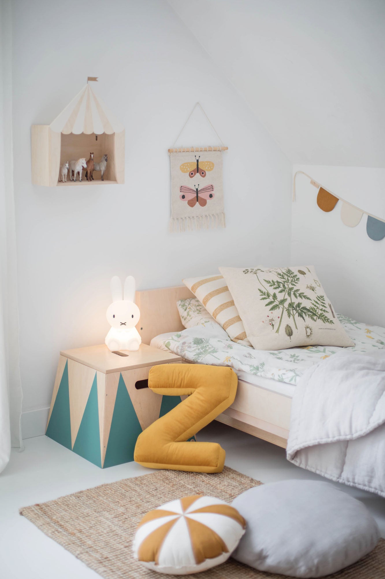 Poduszka literka welurowa Z w kolorze żółtym od Bettys Home oparta o łóżko w pokoju chłopca